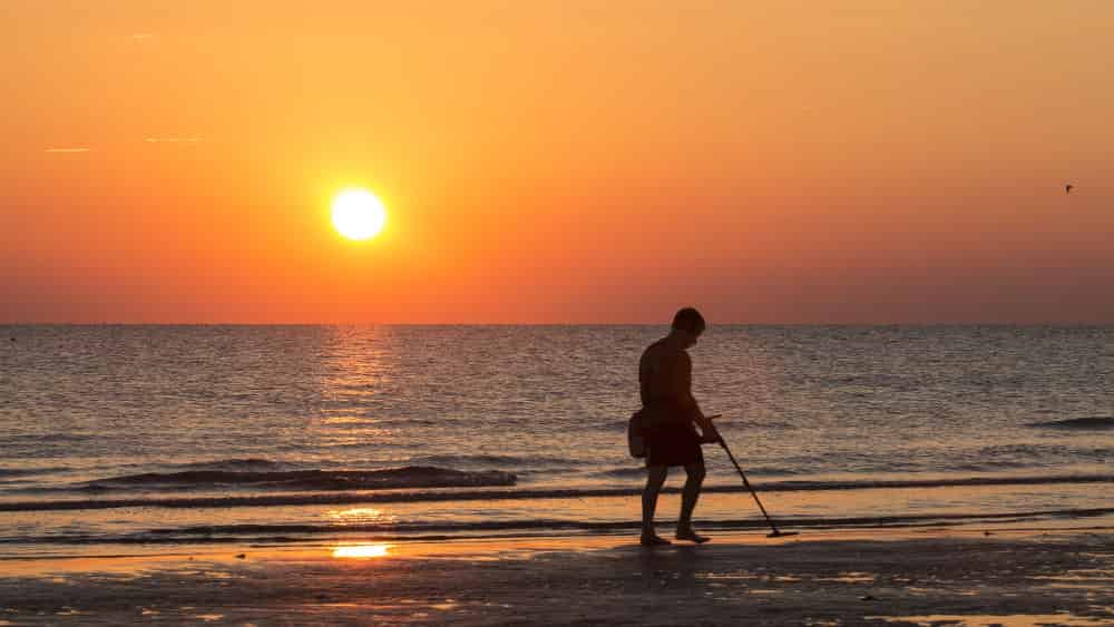 Man using Beach Metal Detector